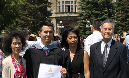 Graduate smiling with his family