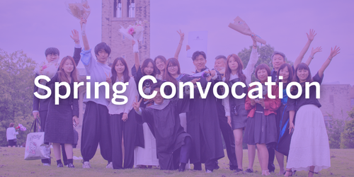 A family standing with their graduate on University College hill on a sunny day